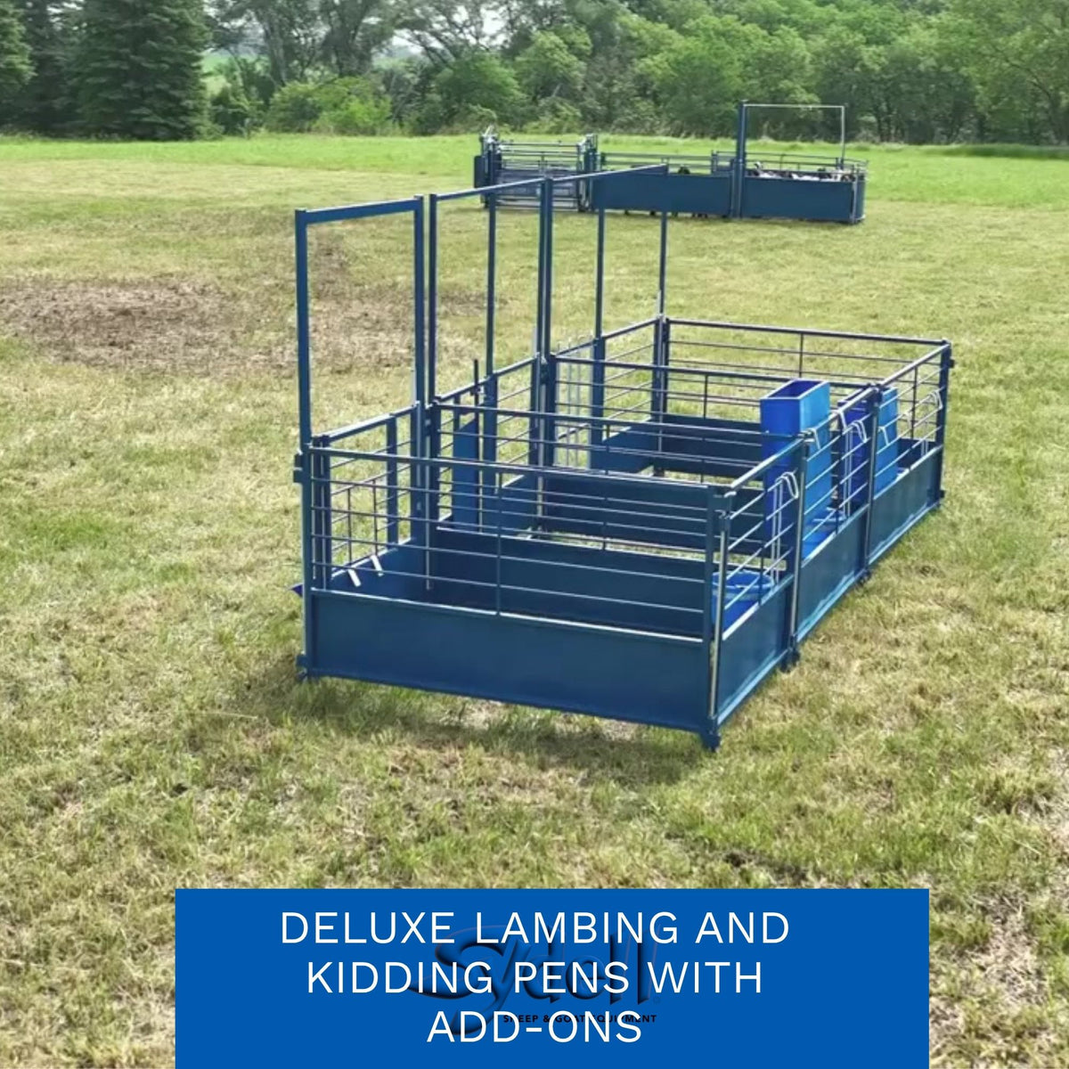 A blue metal lambing and kidding pen structure set in a grassy outdoor field, with a smaller similar unit in the background. A blue text banner at the bottom reads 'DELUXE LAMBING AND KIDDING PENS WITH ADD-ONS'.