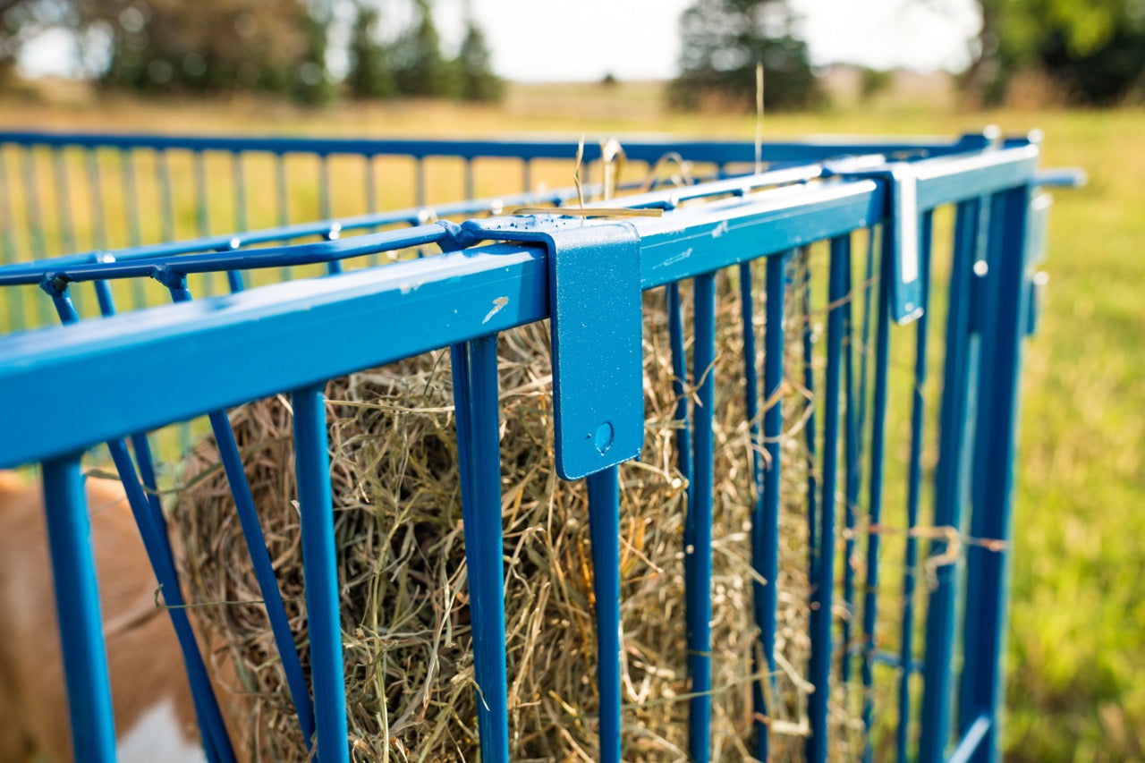 Bale feeder used for hoof trimming, sorting and controlled livestock movement